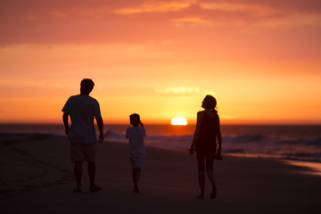 silhouette of family on the beach at dusk in Peru