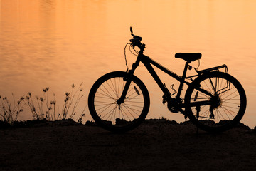 Fototapeta na wymiar Silhouette of bike near the lake