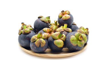 Isolated mangosteen fruits on wooden dish