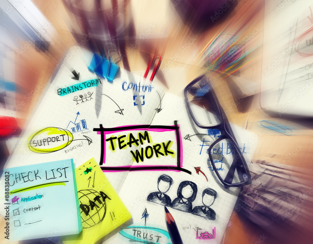 Aufkleber desk with tools and a notebook with ideas about teamwork