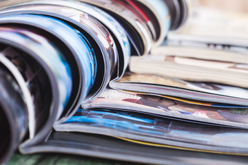 stack of open colorful magazines. information
