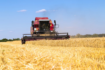 Photo of combine harvester that is harvesting wheat