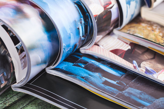 stack of open colorful magazines. information