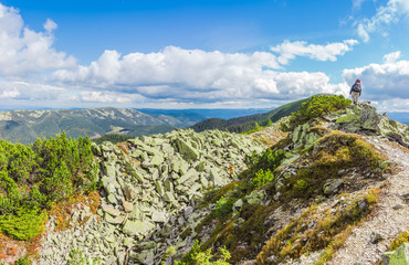 Mountain autumn landscape with single tourist on the ridge