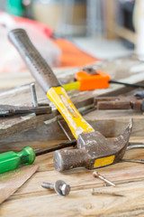 Dirty set of hand tools on a wooden panel