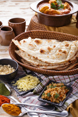 indian naan bread with chicken curry and some ingredients