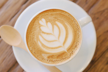 Cup of coffee latte art on wood table