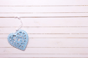 Blue decorative heart on wooden background