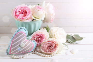 Background with sweet pink roses flowers  and decorative heart