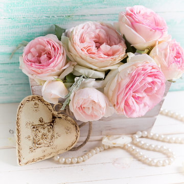 Sweet pink roses in box and decorative heart