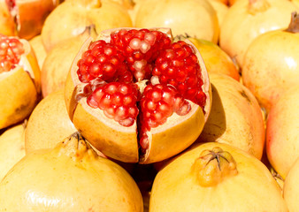 Fresh pomegranates for sale at market. Close up and selective focus