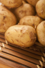 fresh potatoes close up on wooden background