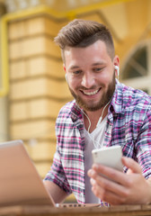 Young hipster with smart phone