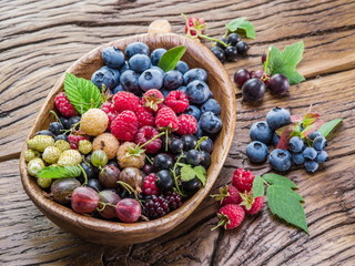 Ripe berries in the wooden bowl.