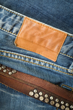 blue jeans with leather belt and label tag