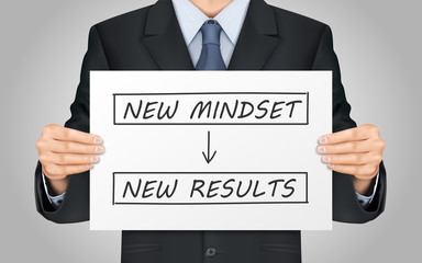 businessman holding new mindset make new results poster