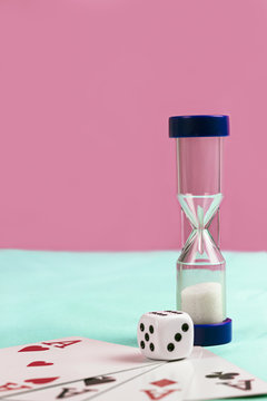 Playing Cards with Blue Sand Timer and Die on Blue and Pink Back