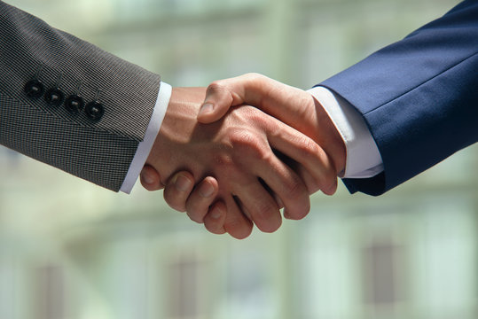 Men in business suits shaking hands