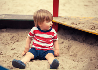 Little boy playing in sandbox