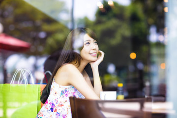 smiling young woman thinking in cafe shop