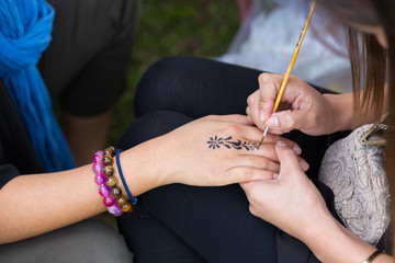 body paint, artist used paintbrush drawing art on hand person