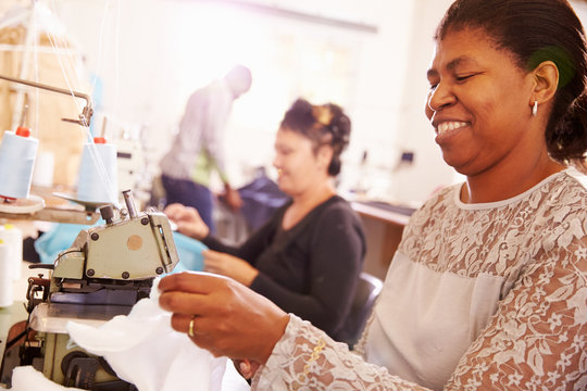 Smiling Woman Sewing At A Community Workshop, South Africa