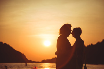 Silhouette couple on sunset background