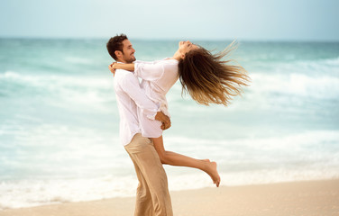 Young couple enjoying together on beach