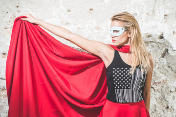 Young woman posing as superhero or wonderwoman