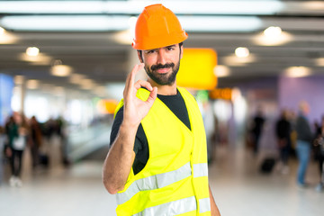 Workman making Ok sign over white background