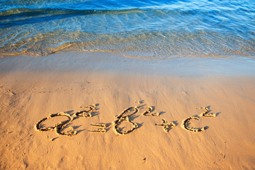 Quadratic equation handwriting on the sand.