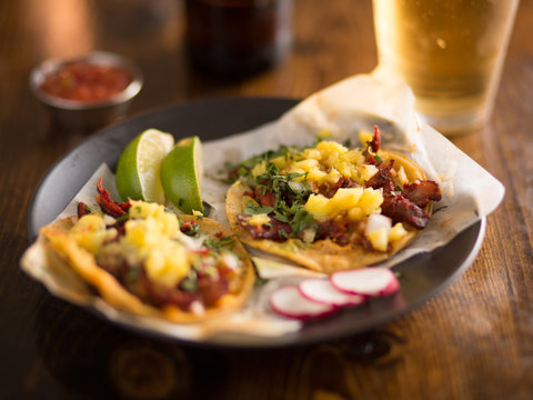al pastor street tacos with pineapple, radish and beer
