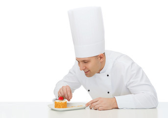 happy male chef cook decorating dessert