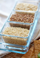 close up of grain in glass bowls on wooden table
