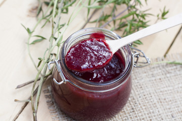 Home made organic cherry jam confiture on a wooden table