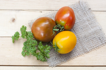 Assorted tomatoes: orange, pink, black tomatoes with parsle