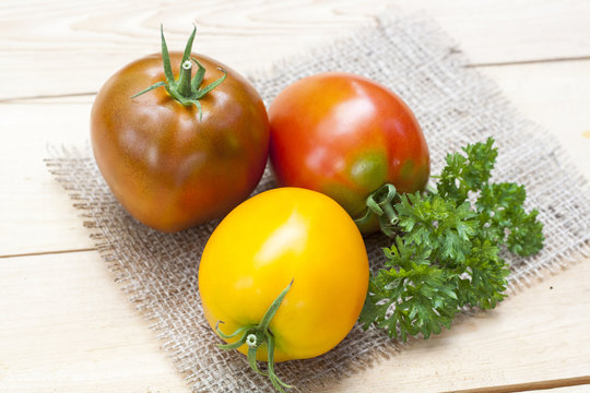 Assorted tomatoes: orange, pink, black tomatoes with parsle