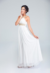 Full length portrait of a happy attractive bride