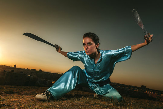 Young Woman Practising Wushu at Sunset