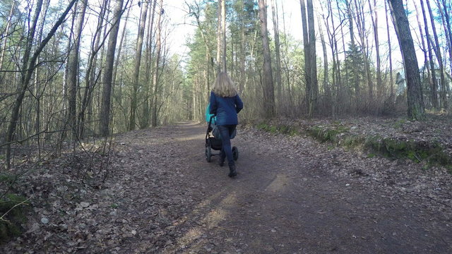 Mother lie and exercise her little baby girl hands on bed at home. Woman care her newborn child health. Happy time spend together. 4K UHD wide angle shot.

