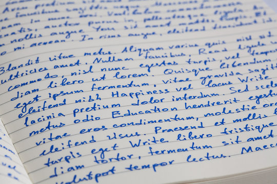 Extreme closeup of open notebook with handwritten  lorem ipsum t