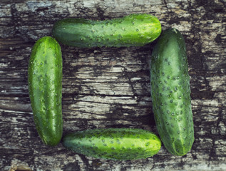 wood background with cucumbers