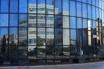 reflection of street and building in a  glass a modern building
