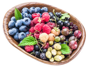 Berries in the wooden bowl on a white.