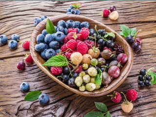 Ripe berries in the wooden bowl.