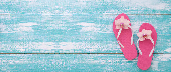 Summer vacation. Pink sandals by swimming pool.