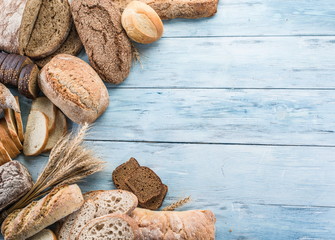 The bread and a wheat on the wooden desk.