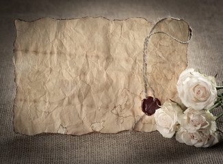 Ancient parchment with red wax seal and roses