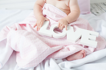 Obraz na płótnie Canvas cute baby under a blanket in bed