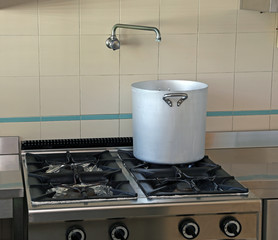 aluminum pot and a tap in the industrial kitchen